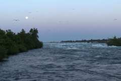 The moon at dusk over the river at Niagara Falls
